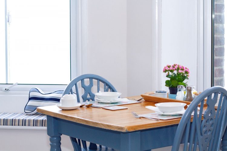 Blue table in breakfast room looking out over sea view